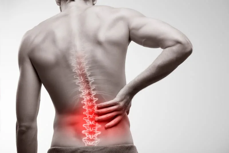 Man holding his lower back with the spine highlighted in red