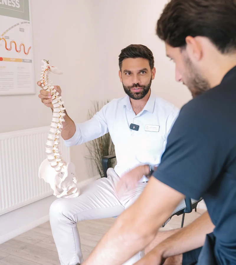 Chiropractor at Life Chiropractic explaining a spine model to a patient